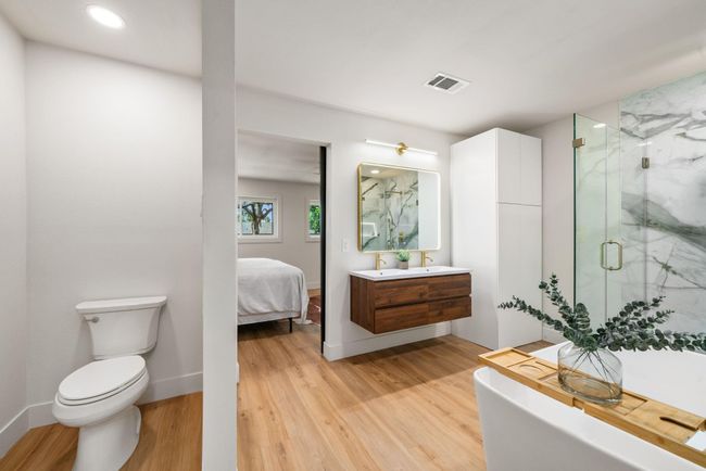 Double vanity, tower storage, glass shower, and Japanese soaking tub | Image 22