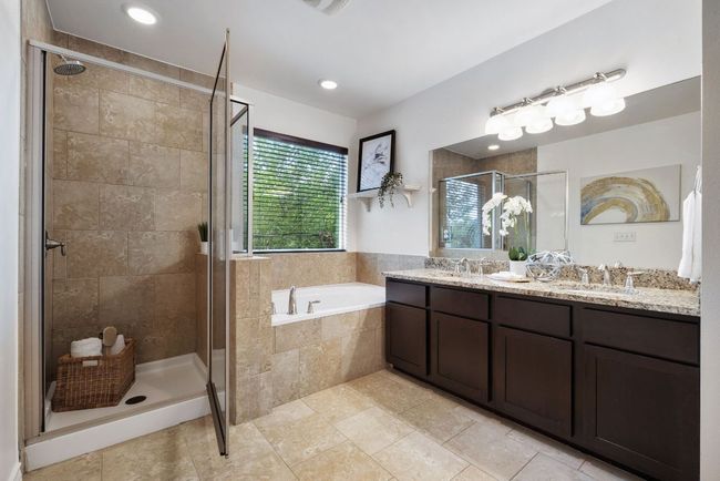 Primary bathroom features a garden tub, separate walk-in shower and dual vanities. | Image 24