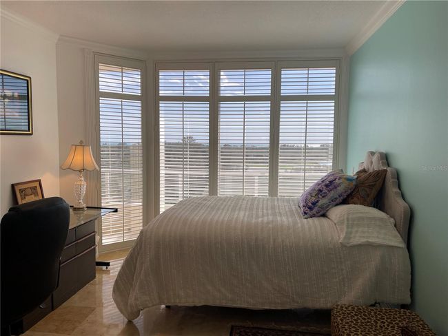 Second bedroom suite features plantation shutters and crown mouldings | Image 29