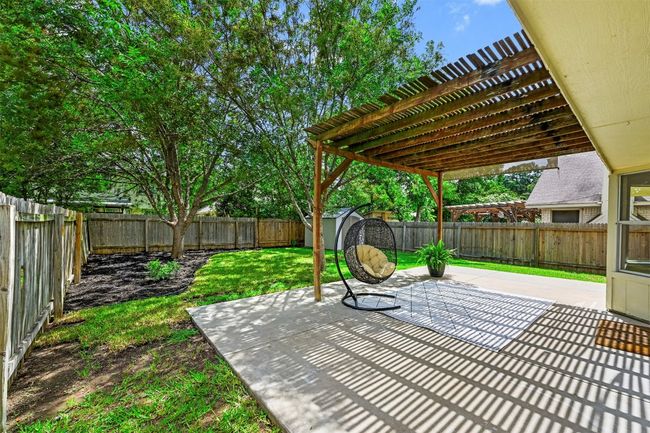 Fenced backyard with a patio area, a storage shed, and a pergola | Image 33