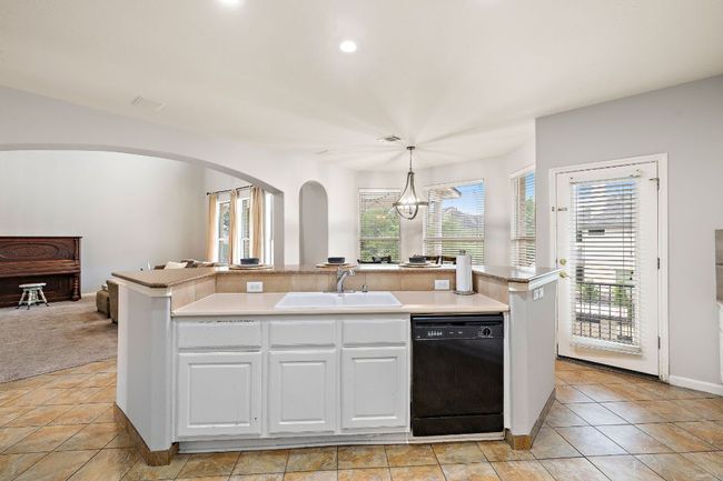 The kitchen has lots of countertop space and opens to the living room and breakfast nook. | Image 18
