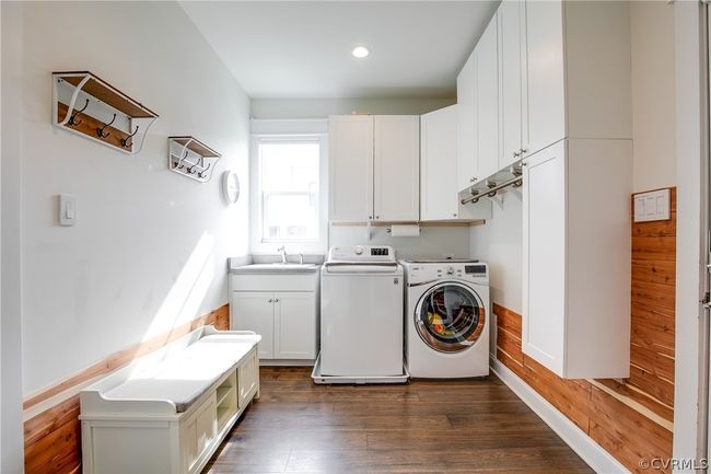 Laundry room with dark hardwood / wood-style flooring, sink, cabinets, and separate washer and dryer | Image 36