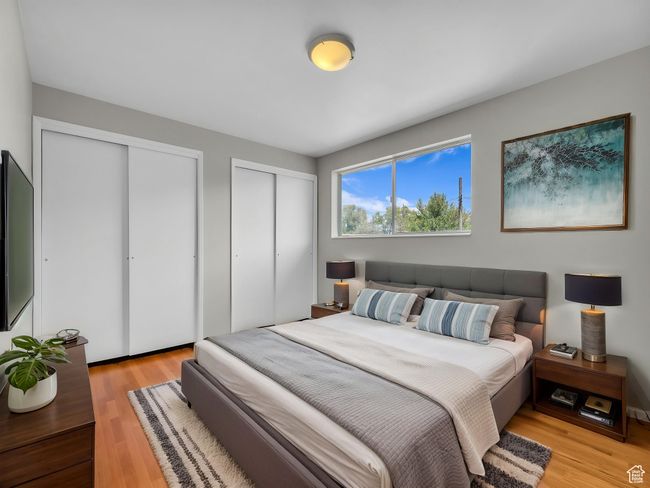 Primary bedroom featuring light wood-type flooring and two closets | Image 10