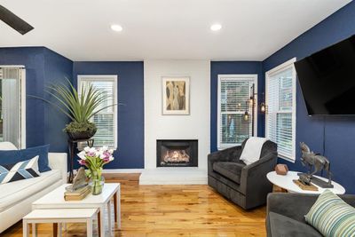 Living room featuring hardwood / wood-style floors and a large fireplace | Image 2