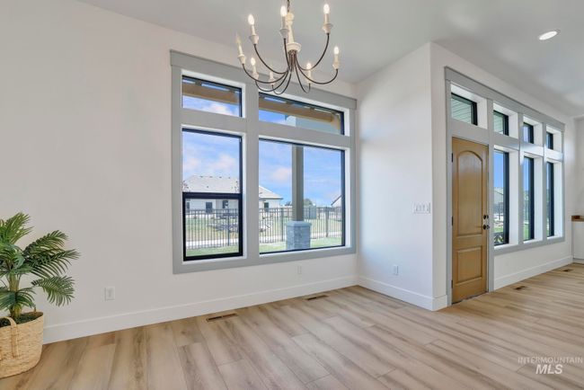 Spare room with a chandelier, light wood finished floors, and recessed lighting | Image 11