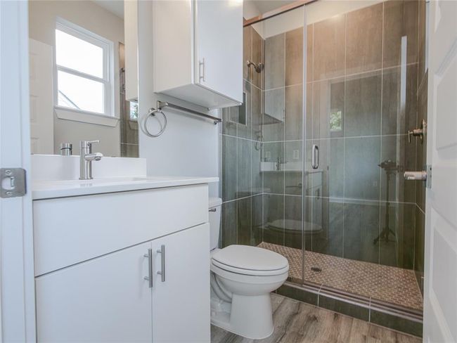 Full bath with vanity, a stall shower, and wood finished floors | Image 18