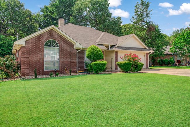 Ranch-style home with concrete driveway, a front lawn, and brick siding | Image 18