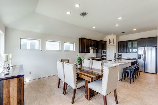 Dining space featuring recessed lighting, vaulted ceiling, and light tile patterned flooring | Image 10