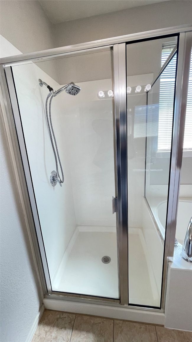 Full bath featuring a shower stall and tile patterned floors | Image 19