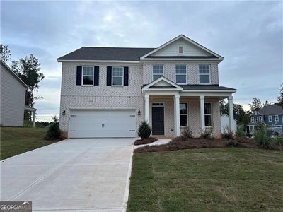 View of front of house with a garage, a front lawn, and covered porch | Image 2