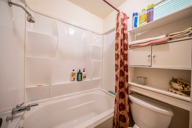 Full bath with shower / bath combo with shower curtain and a textured ceiling | Image 18