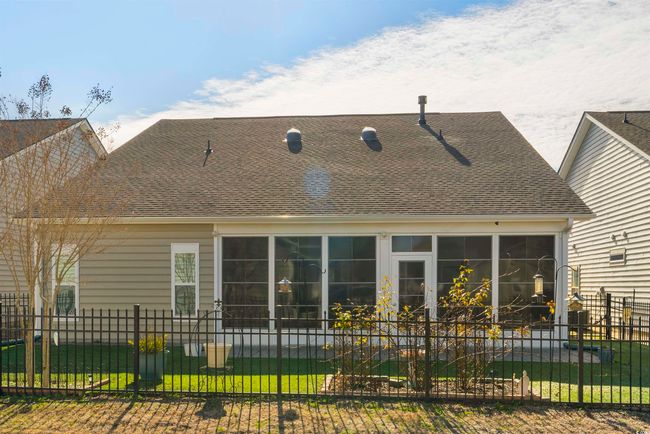 Back of house featuring a sunroom and a lawn | Image 37