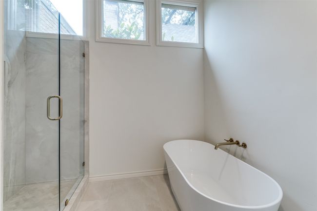 Full bathroom with a freestanding bath, a stall shower, and tile patterned floors | Image 18