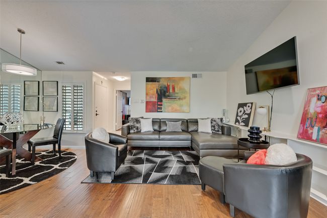 Living area featuring lofted ceiling and wood finished floors | Image 4