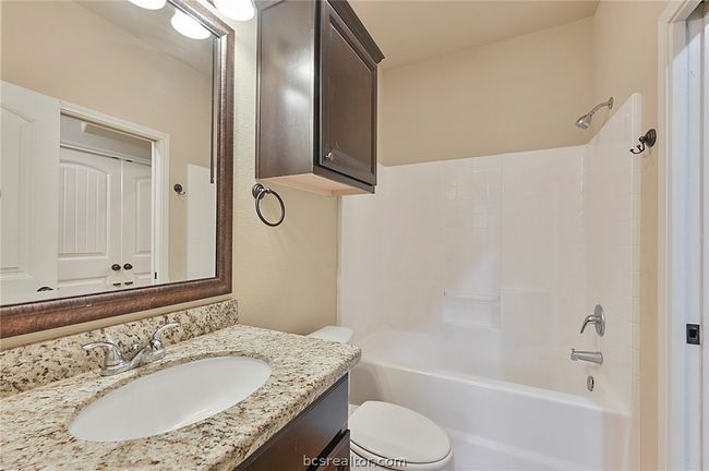 Full bath featuring vanity, tub / shower combination, and toilet | Image 12