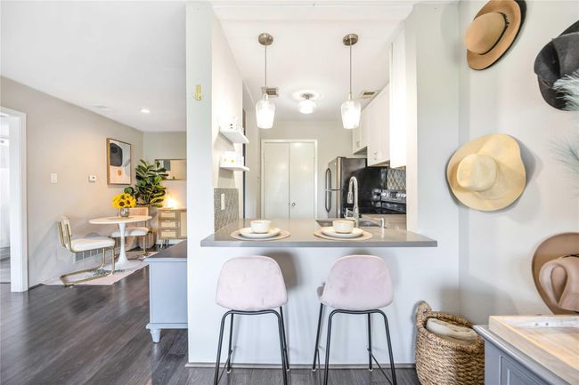 The breakfast bar with seating and adjacent dining area provide ample seating. | Image 6
