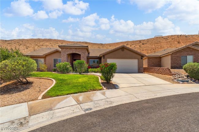 View of front of property with an attached garage, a front lawn, a tile roof, stucco siding, and driveway | Image 4