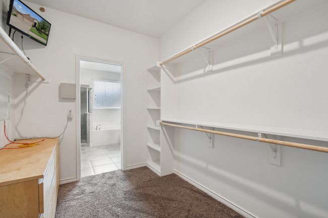 Walk in closet featuring light carpet | Image 20