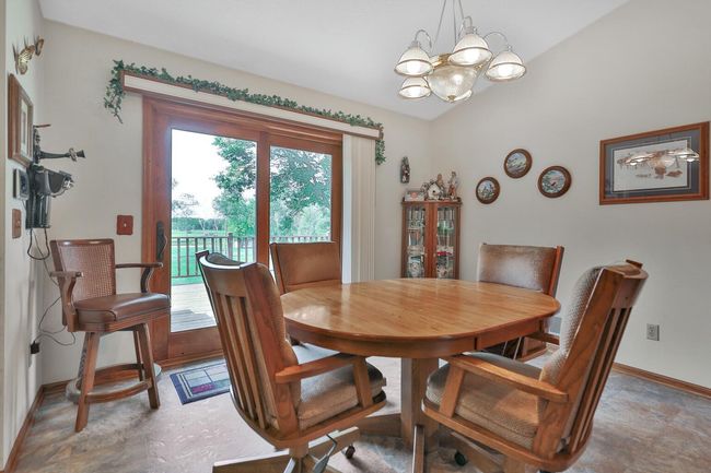 Dining area with patio doors to rear deck. | Image 17