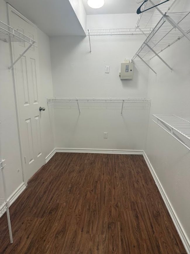 Walk in closet featuring dark wood-type flooring | Image 8