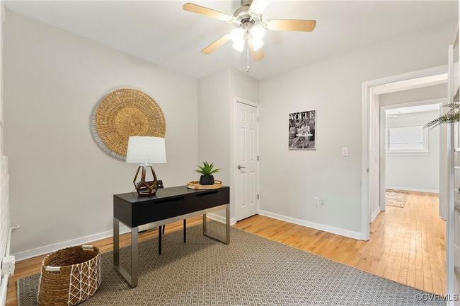 Office with light wood finished floors and a ceiling fan | Image 18