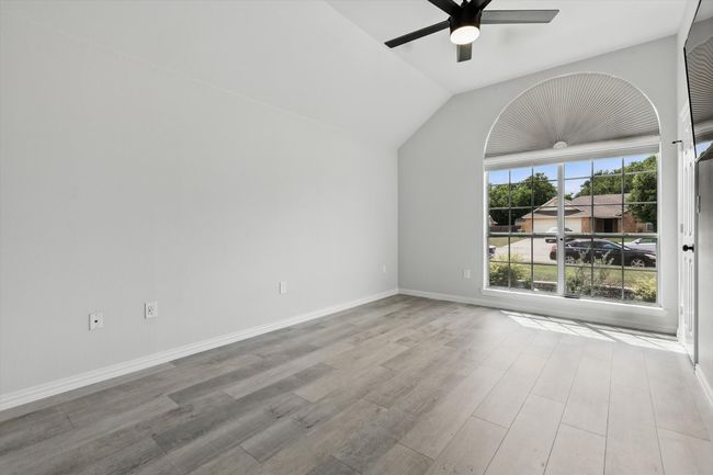 Empty room featuring ceiling fan, wood finished floors, vaulted ceiling, and baseboards | Image 18