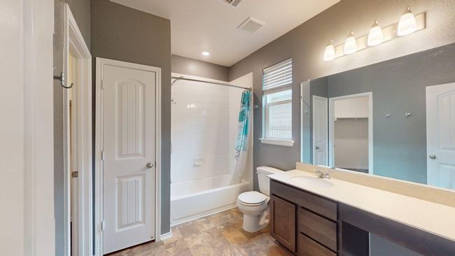 Bathroom featuring vanity, toilet, visible vents, and shower / tub combo with curtain | Image 9