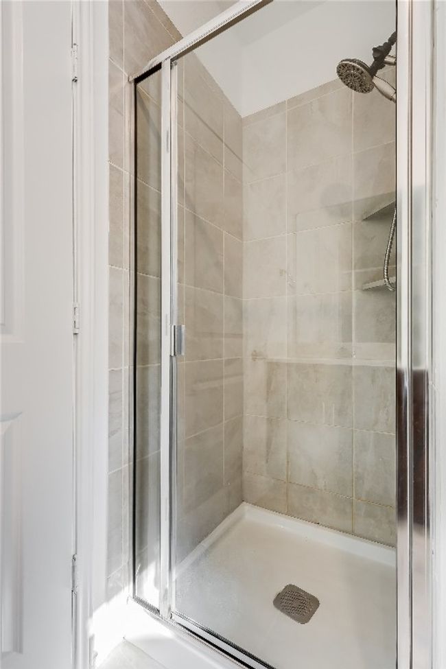 Garage apartment bathroom with a shower stall | Image 38