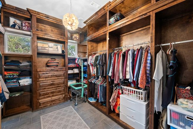 Primary closest is not only beautiful but functional with space for everything as well as a bench for added convenience. | Image 27