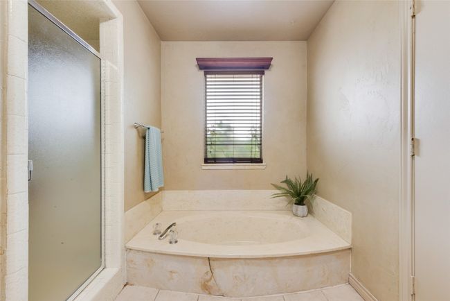 Full bathroom featuring a stall shower, a bath, and tile patterned floors | Image 23