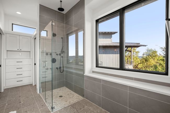 The large walk-in shower is complete glass enclosure, rain head shower, and spa-like finishes for the ultimate personal retreat. | Image 13