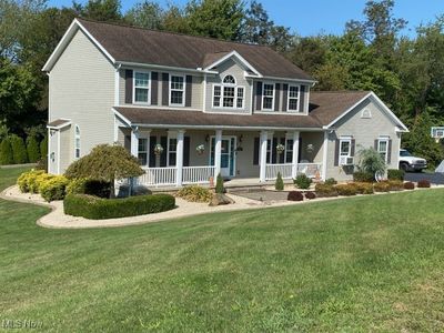 Colonial home with a porch and a front lawn | Image 2