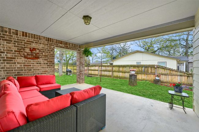 View of patio with an outdoor living space and a fenced backyard | Image 26