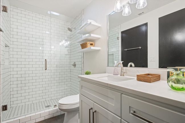 Bathroom with a shower stall and vanity | Image 14