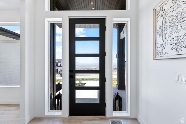 Entryway with a wealth of natural light, wood finished floors, and baseboards | Image 8