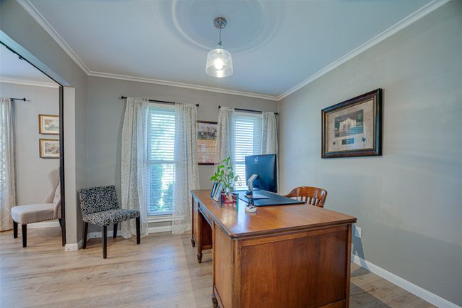 Office space with crown molding and light wood-style flooring | Image 7