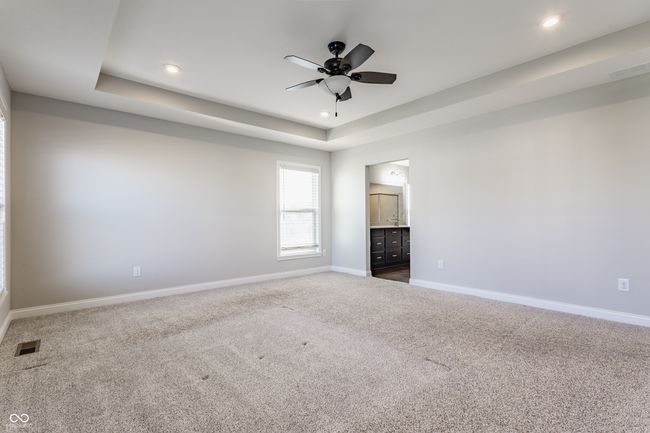 unfurnished living room with ceiling fan, carpet floors, visible vents, and baseboards | Image 27