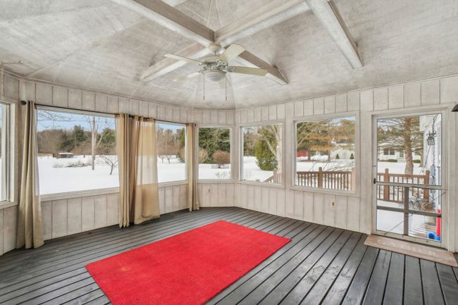 Screened porch built on deck overlooks rear yard. | Image 30