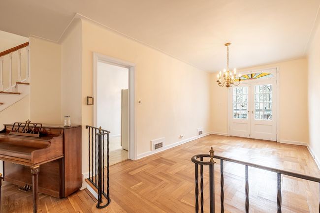 Dining space featuring stairway, visible vents, a notable chandelier, and baseboards | Image 4