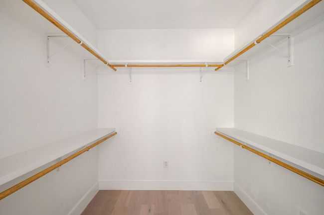 Walk in closet with light wood finished floors | Image 39