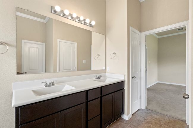 Bathroom with crown molding, double vanity, and tile patterned floors | Image 18
