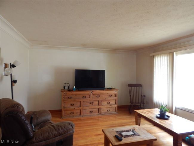 Freshly Painted Living room Hardwood flooring. Large Picture Window with an abundance of natural light. | Image 6