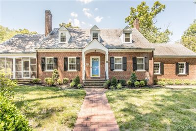 New england style home with a front lawn | Image 1