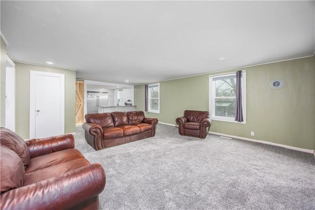 Carpeted living room with visible vents, recessed lighting, and baseboards | Image 28