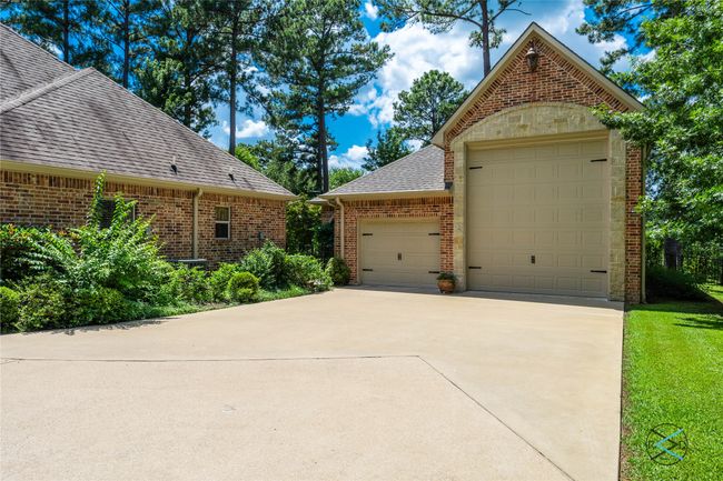 View of property exterior featuring a garage and a yard | Image 33