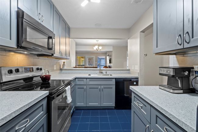The kitchen offers a direct line of sight to the dining and living rooms. | Image 10
