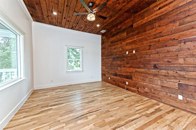 Living Room featuring wooden ceiling, ceiling fan, wood finished floors, recessed lighting, and wood walls | Image 8