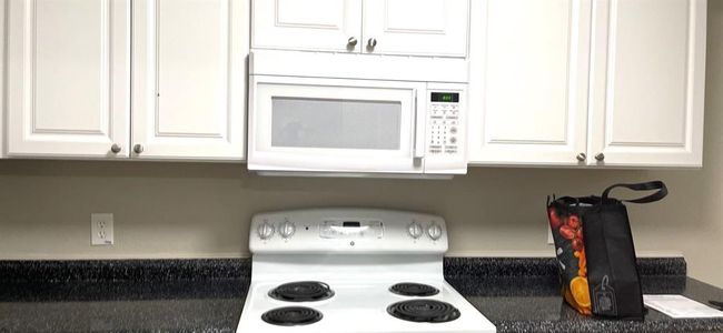 8836 Kitchen featuring stove and white cabinetry | Image 17