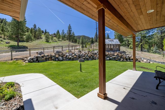View of yard with a patio area, a mountain view, and an outdoor structure | Image 46