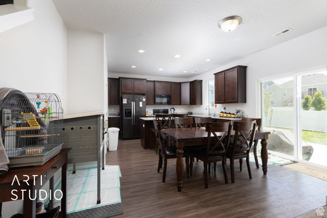 Dining area featuring dark wood finished floors and recessed lighting | Image 10